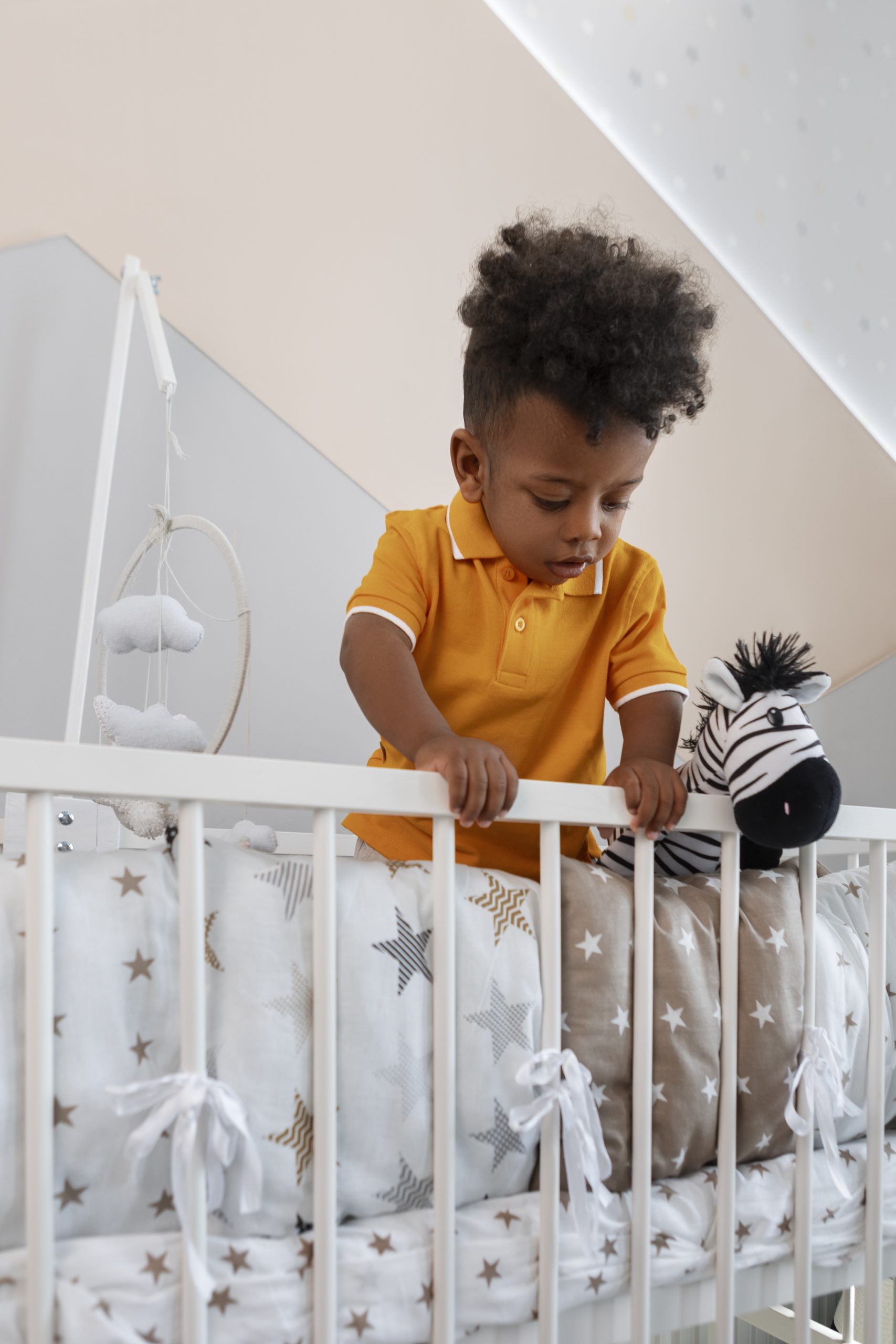 portrait young boy playing with his stuffed animal toy